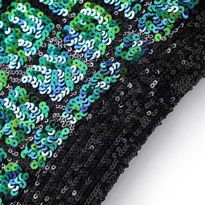 Close-up of a green sequin mini dress showcasing shimmering sequins in varying shades of green and blue