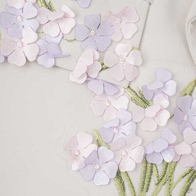 Close-up of ivory flower detail pantsuit for women showcasing delicate floral embroidery