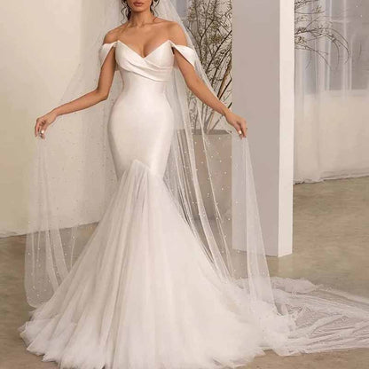 Elegant lace satin off shoulder bridal gown with a mermaid silhouette and detachable veil