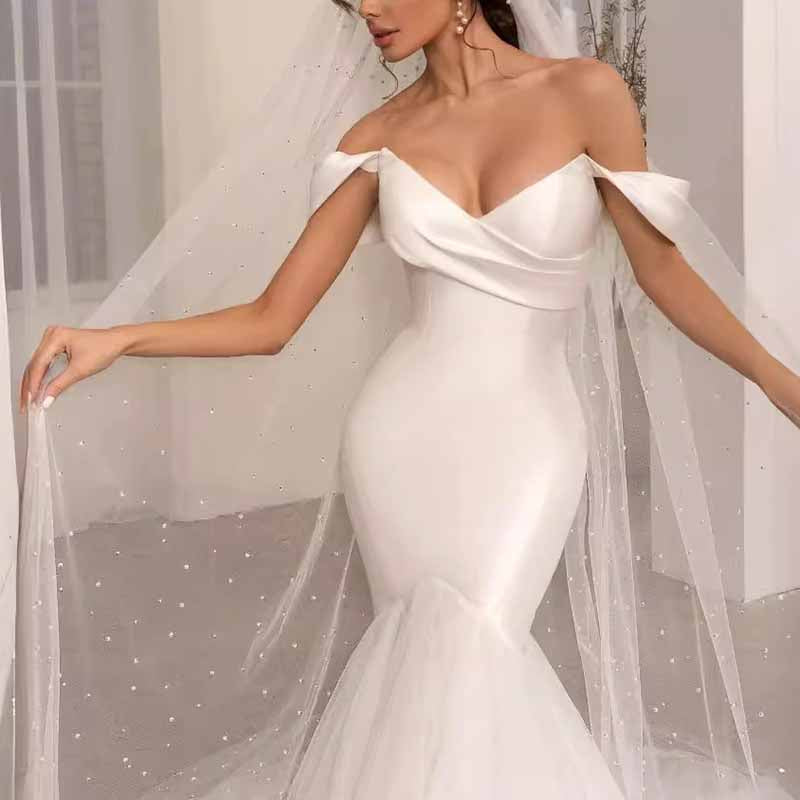 Elegant lace satin off shoulder bridal gown with flowing veil for a stunning wedding look