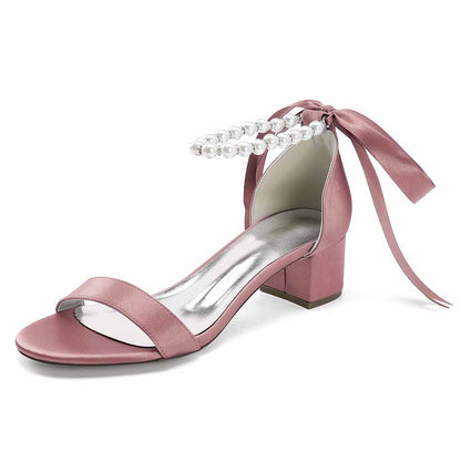 Stylish lace up chunky heel dress shoes in pink satin with pearl detailing and a ribbon tie