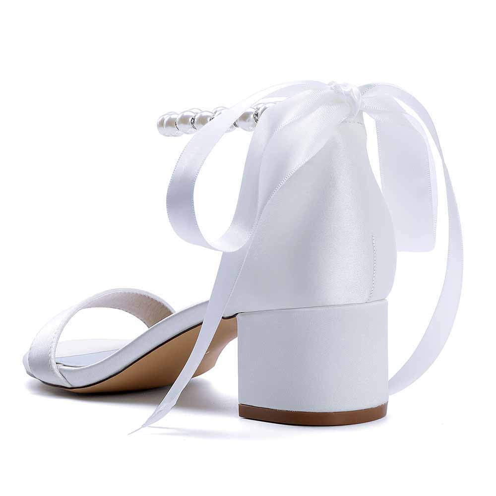 White lace up chunky heel dress shoes with ribbon tie and pearl accents for stylish elegance