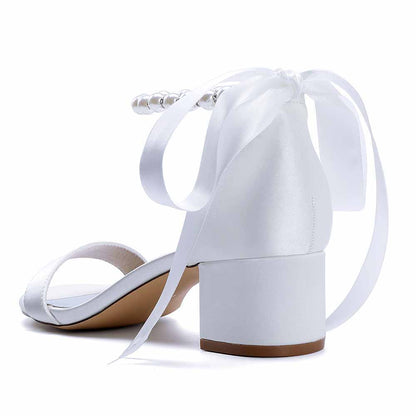 White lace up chunky heel dress shoes with ribbon tie and pearl accents for stylish elegance
