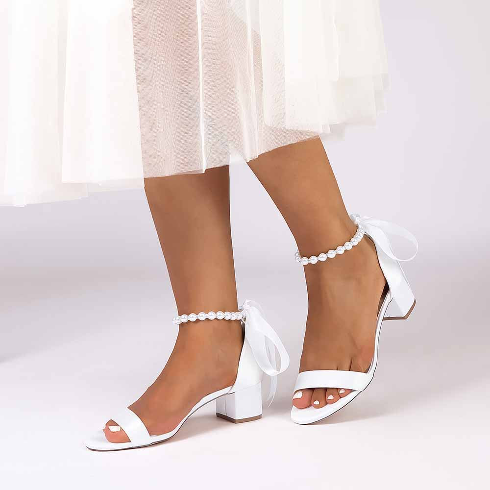 Elegant lace up chunky heel dress shoes in white with ankle bow detail for stylish occasions