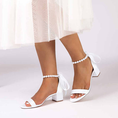 Elegant lace up chunky heel dress shoes in white with ankle bow detail for stylish occasions