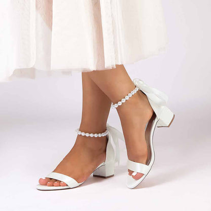 Elegant lace up chunky heel dress shoes in white with ankle straps and bow detail for stylish occasions