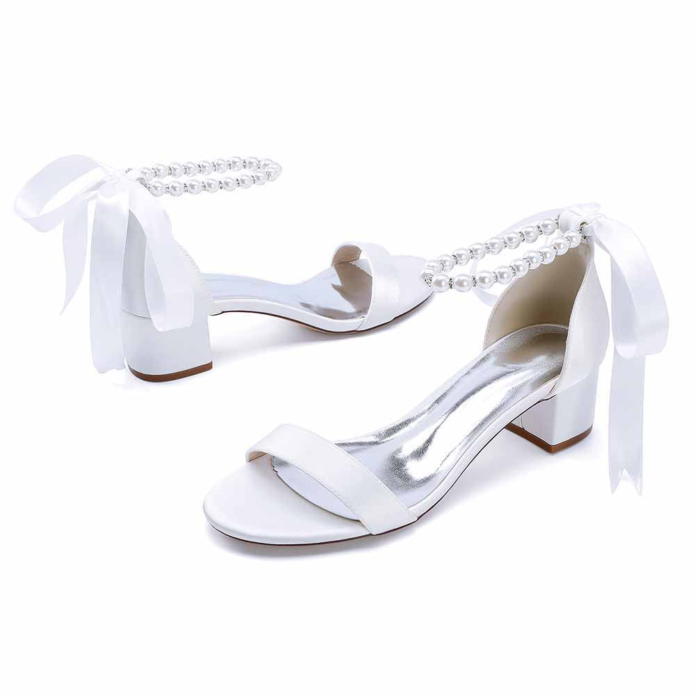 Elegant lace up chunky heel dress shoes in white with pearl embellishments and ribbon detailing