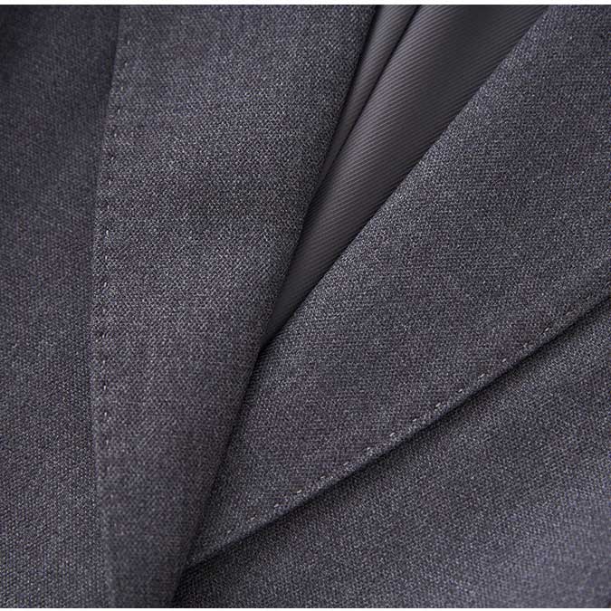Close-up of a ladies tailored pantsuit for events highlighting fine fabric details and elegant design