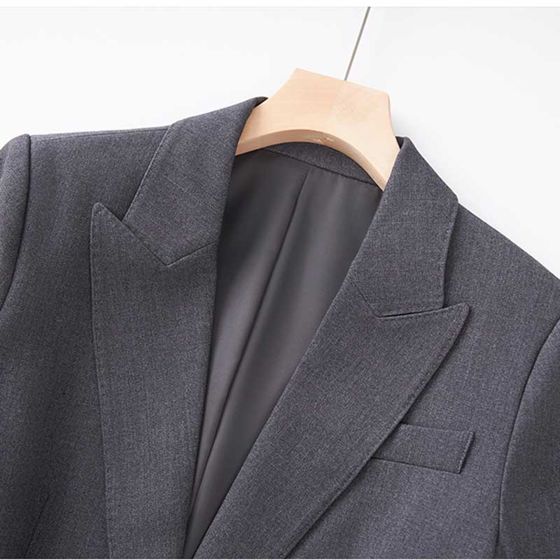 Close-up of a ladies tailored pantsuit for events showcasing a sleek gray blazer design