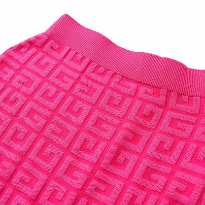 Bright pink long knitted cardigan set featuring a textured geometric pattern for stylish layering