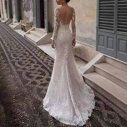 Elegant long sleeve lace mermaid wedding dress featuring intricate floral details and a stunning back design