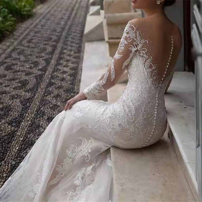 Elegant long sleeve lace mermaid wedding dress featuring intricate detailing and a beautiful back design