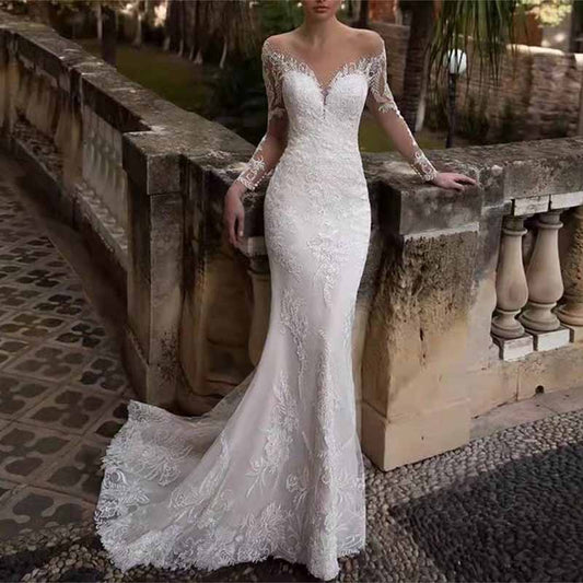 Elegant long sleeve lace mermaid wedding dress with a fitted silhouette and stunning train