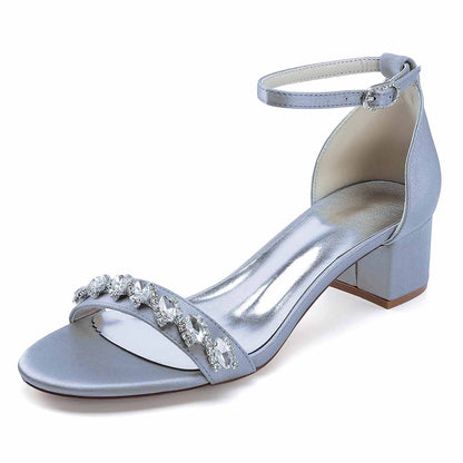 Elegant low block heel dress sandals for wedding in silver with jewel embellishments and ankle strap