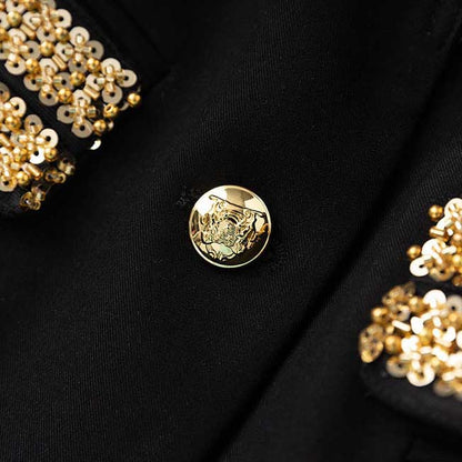 Close-up of luxury black skirt suit for weddings featuring intricate gold detailing and elegant buttons