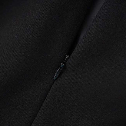 Close-up of luxury black skirt suit for weddings with detailed zipper craftsmanship and premium fabric