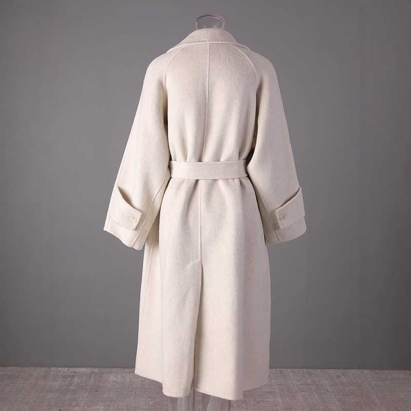 Back view of mid-length wool coat stylish comfort with a belted waist and wide sleeves