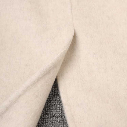 Close-up of a mid-length wool coat stylish comfort showing soft fabric detail