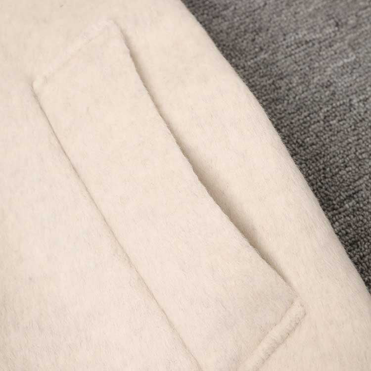 Close-up of a cozy mid-length wool coat stylish comfort with a soft texture and pocket detail