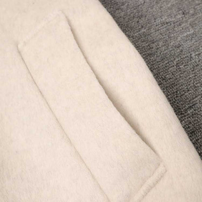 Close-up of a cozy mid-length wool coat stylish comfort with a soft texture and pocket detail