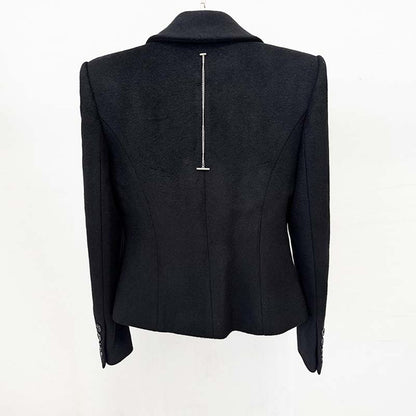 Back view of a minimalist double-breasted wool coat in black with sleek tailoring details