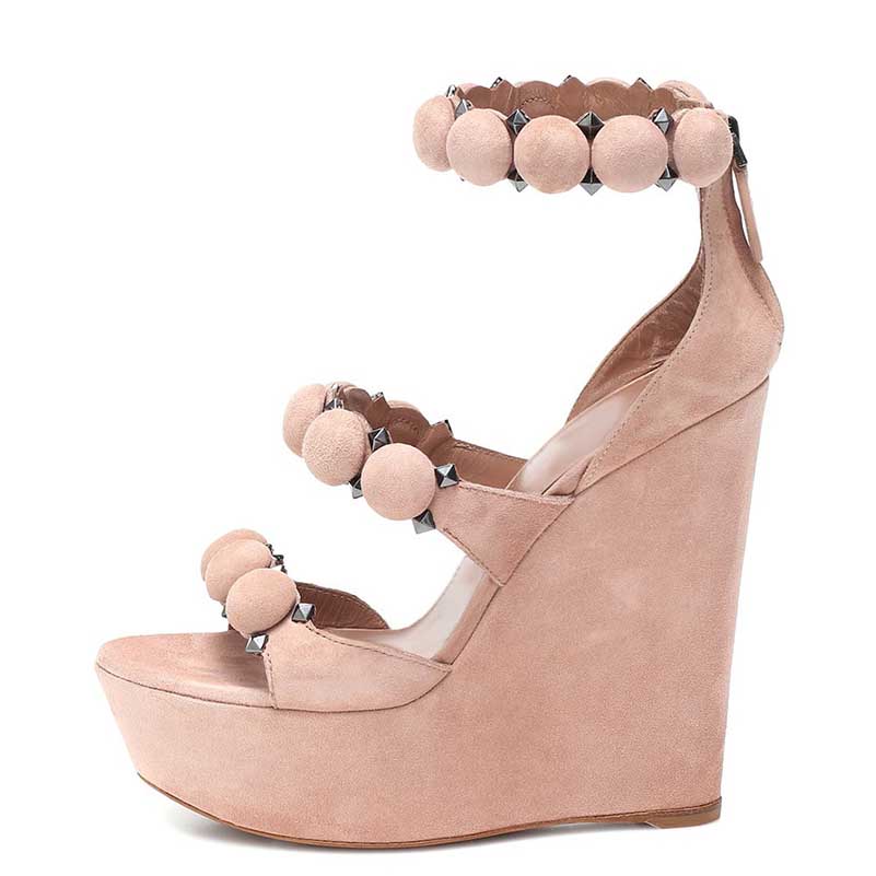 Stylish nude wedge sandals for special occasions featuring decorative pom poms and a high platform design