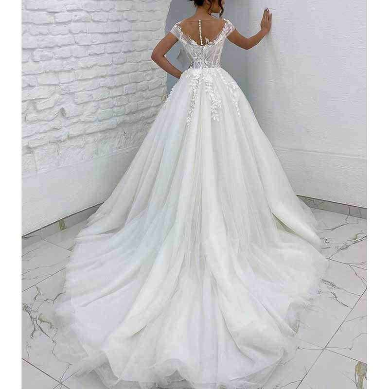 Elegant off the shoulder princess wedding dress with a flowing train and intricate lace detailing