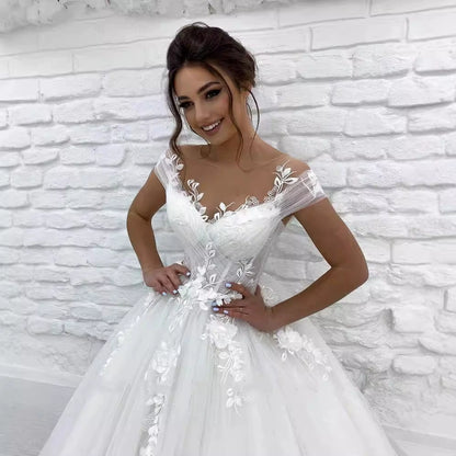 Elegant off the shoulder princess wedding dress with floral embroidery and a flowing skirt