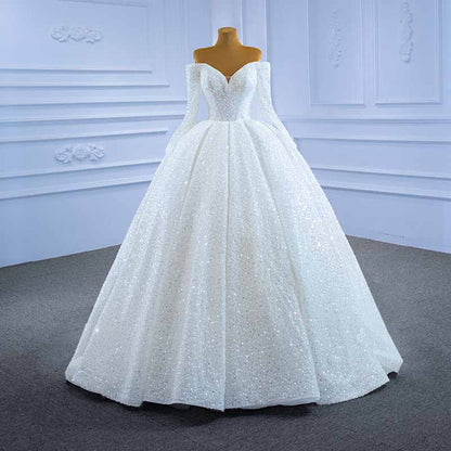 Elegant off the shoulder sequin wedding dress featuring a luxurious full skirt and fitted bodice