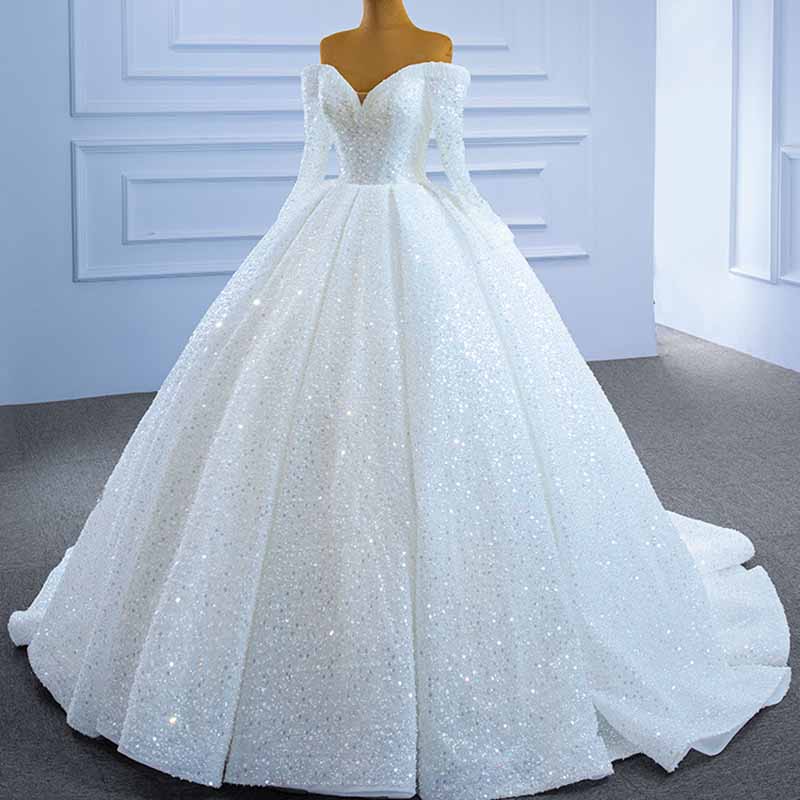 Elegant off the shoulder sequin wedding dress with a voluminous skirt and long sleeves in white