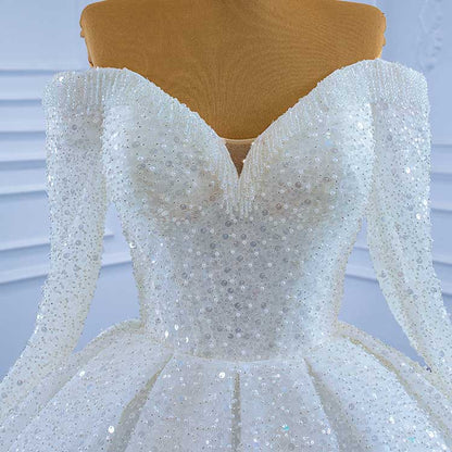 Elegant off the shoulder sequin wedding dress with a sweetheart neckline and shimmering details