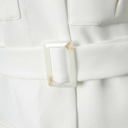 Close-up of off-white belted mini dress with pockets showcasing the stylish belt detail