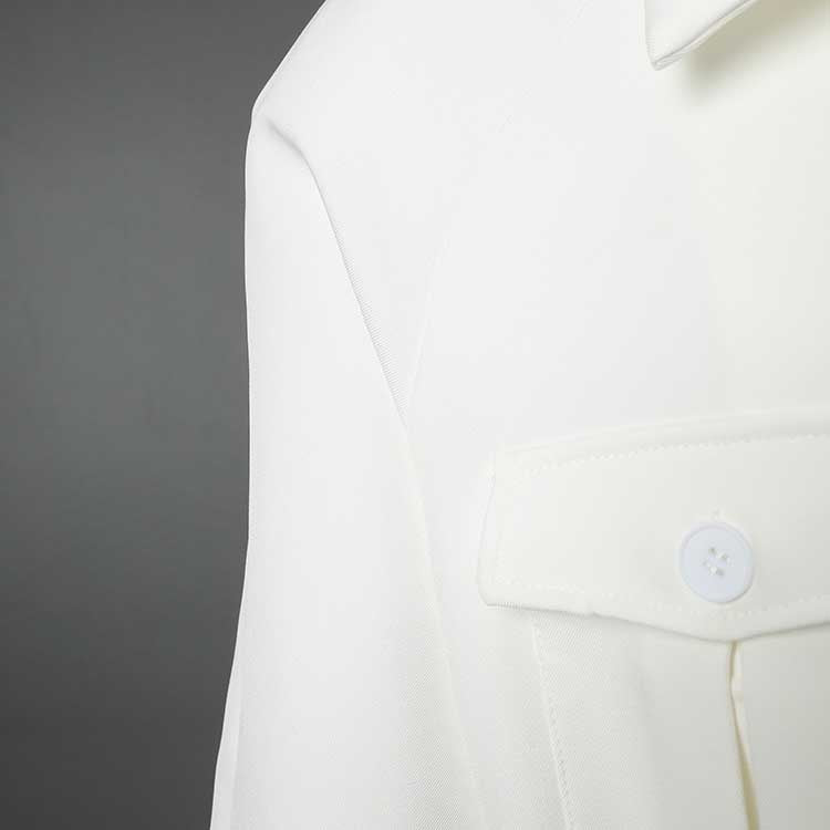 Close-up of the off-white belted mini dress with pockets showcasing button details and fabric texture