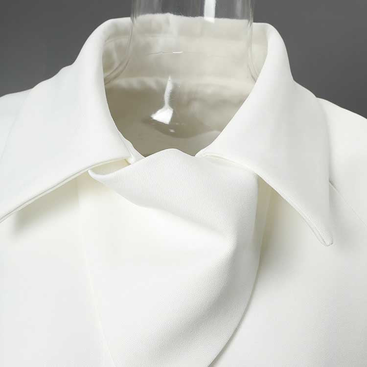 Close-up of off-white belted mini dress with pockets showcasing collar and fabric details