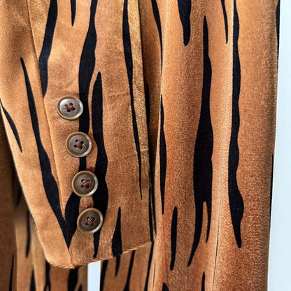 Close-up of buttons on a stylish one button velvet pantsuit for women with a bold tiger print design