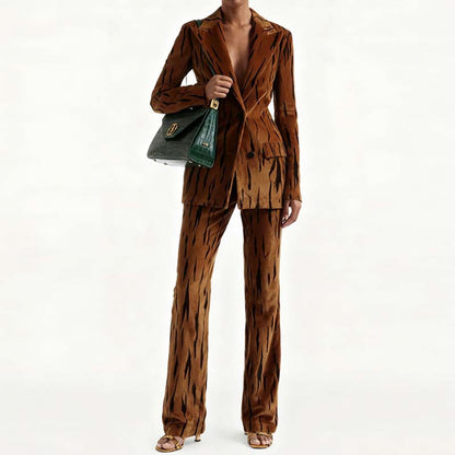 Stylish one button velvet pantsuit for women in brown with a chic pattern, paired with a handbag