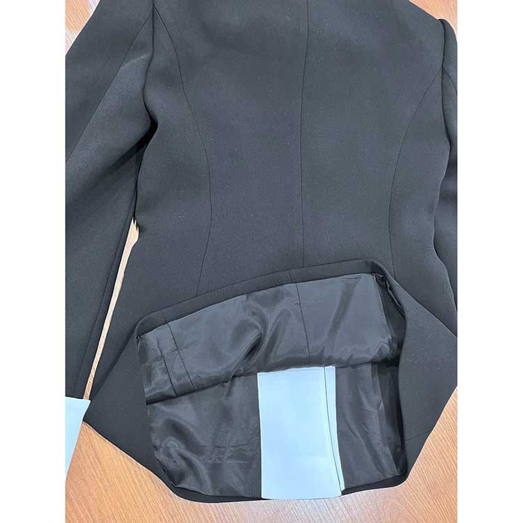 Close-up of the interior pocket of a one button white collar blazer for women by sd-hk