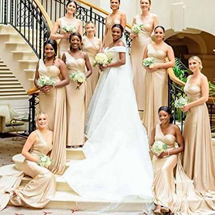Group of bridesmaids in elegant one shoulder satin bridesmaid dresses in soft beige shade