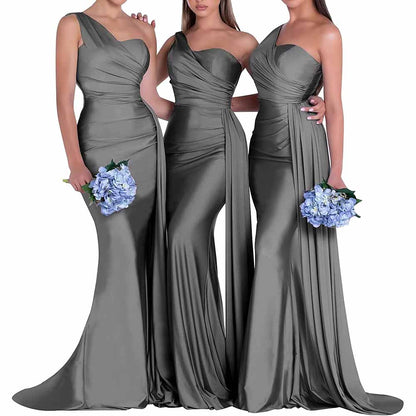 Three elegant one shoulder satin bridesmaid dresses in gray, featuring fitted silhouettes and floral bouquets