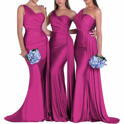 Three models in one shoulder satin bridesmaid dresses in vibrant fuchsia with elegant draping