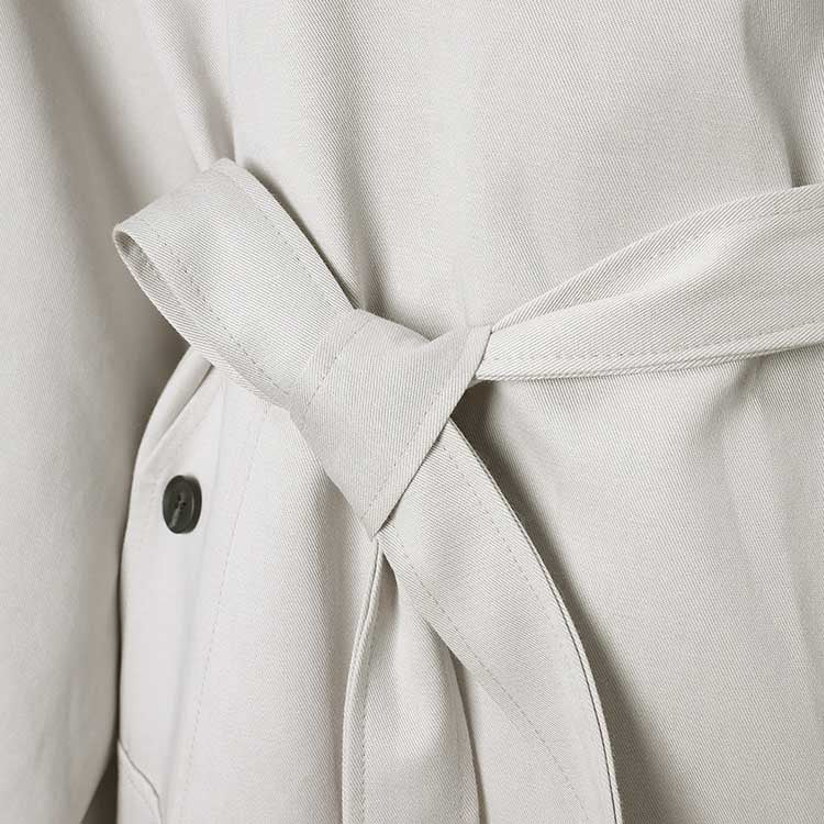 Stylish oversized women's trench coat in light fabric with a tied waist detail