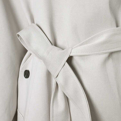 Stylish oversized women's trench coat in light fabric with a tied waist detail