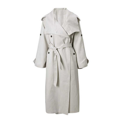 Light beige oversize women's trench coat with wide lapels and a belted waist for a stylish look
