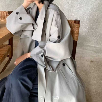 Stylish oversize women's trench coat in light gray, perfect for layering in any season