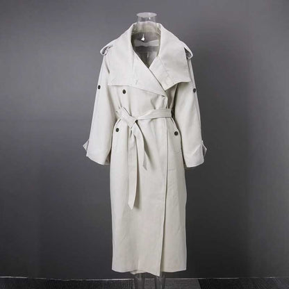 Oversize women's trench coat in light beige with a belted waist and stylish lapels