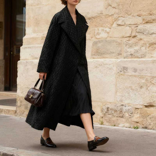 Stylish woman in an oversized black winter jacket for women, paired with a dress and loafers