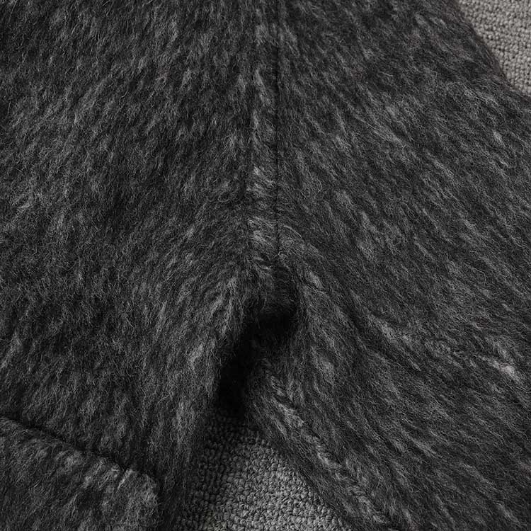 Close-up of an oversized wool blend coat grey showcasing the textured fabric and stitching details