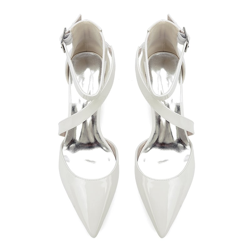 Elegant white patent leather bridal heels with a stylish pointed toe and cross-strap design