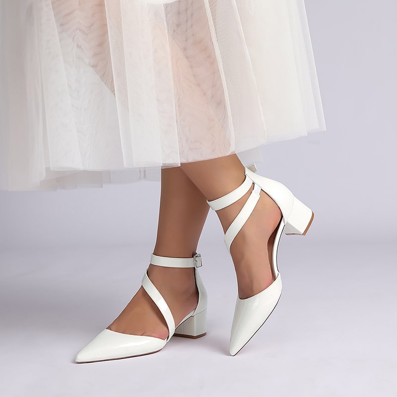 Elegant patent leather bridal heels with ankle straps and a chic pointed toe design