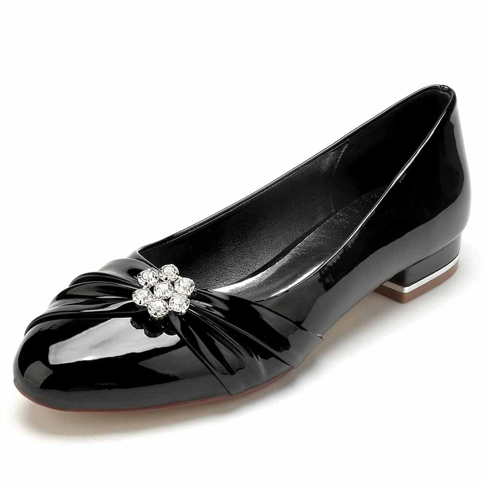 Elegant patent leather wedding shoes with a decorative flower embellishment for bridal wear